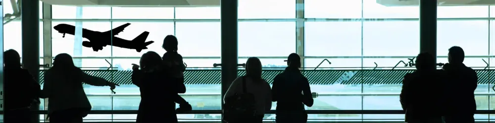people looking out the window at the airport